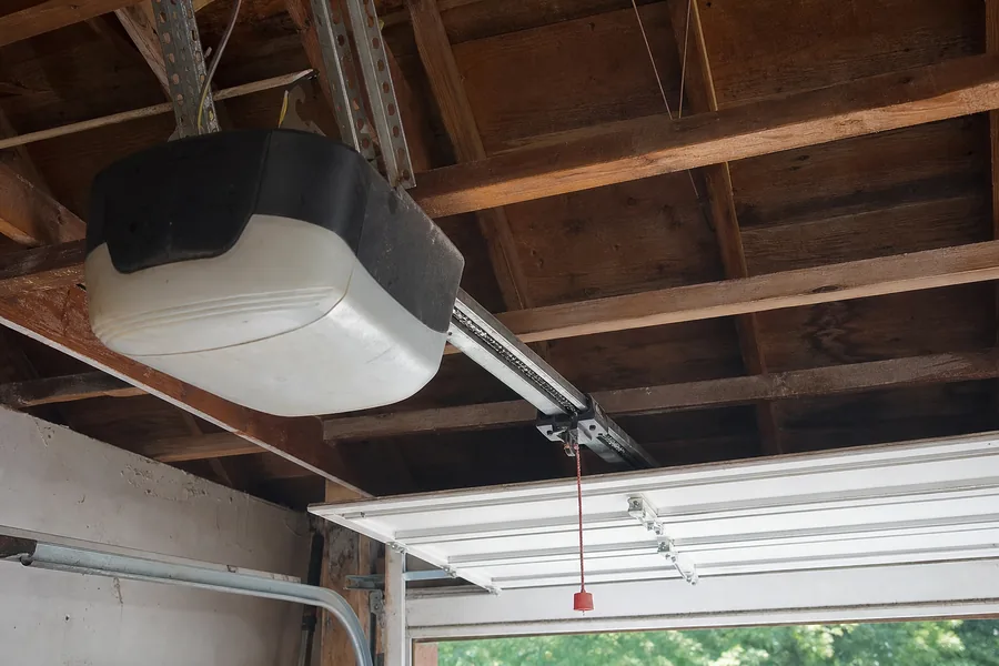 Opener rail and trolley above a two-car garage door