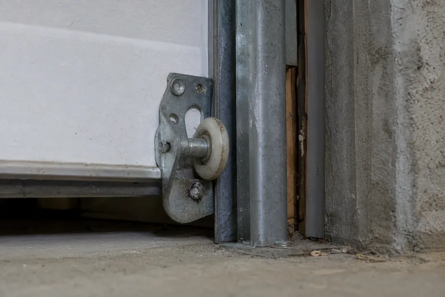 Garage door track and safety sensor bracket