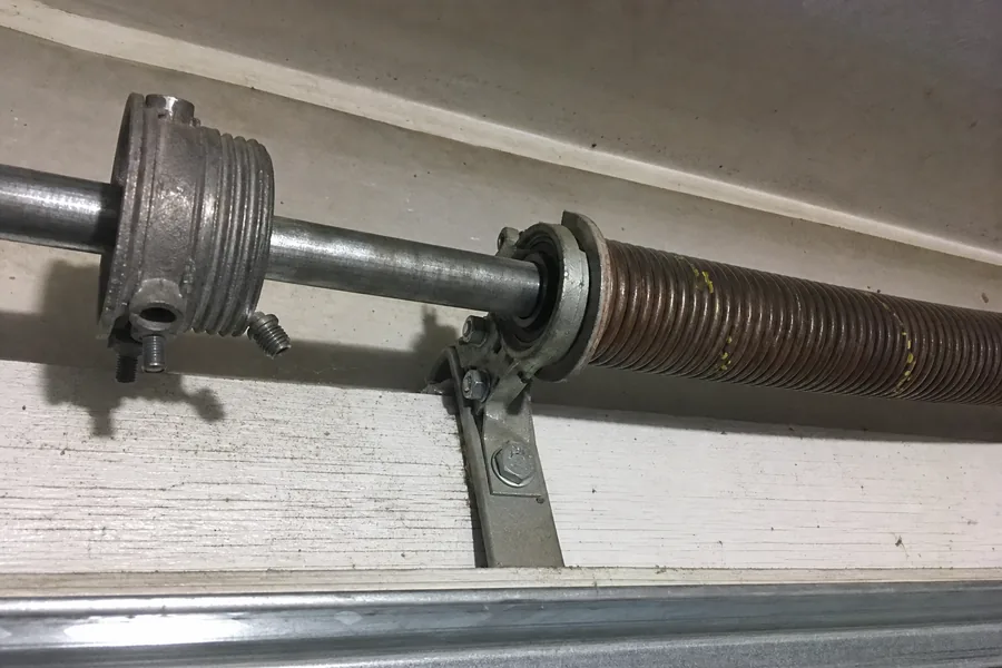 Torsion spring, winding cone and center bearing above a garage door in Springfield, MO